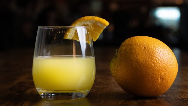 Mimosa and an orange on a table.